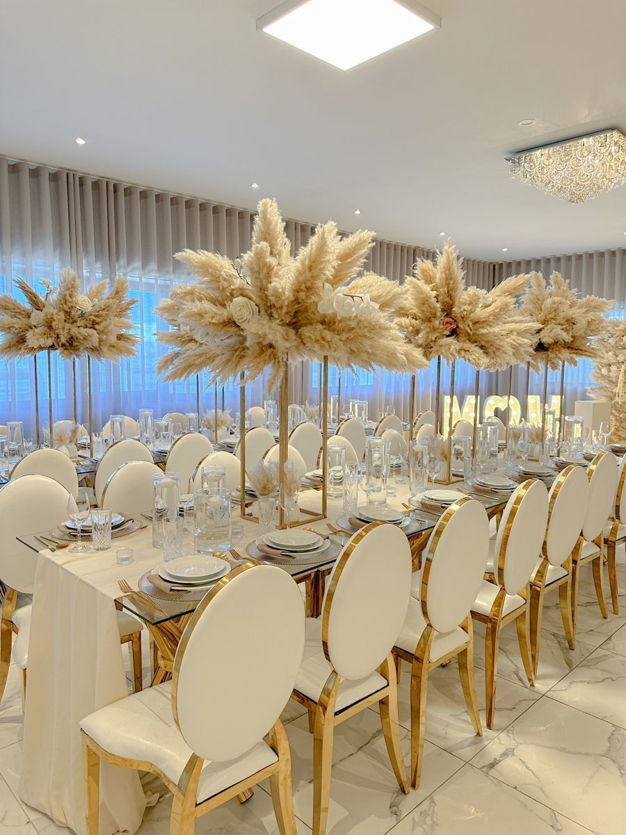Styled event tables with seating, centerpieces, linens, and place settings